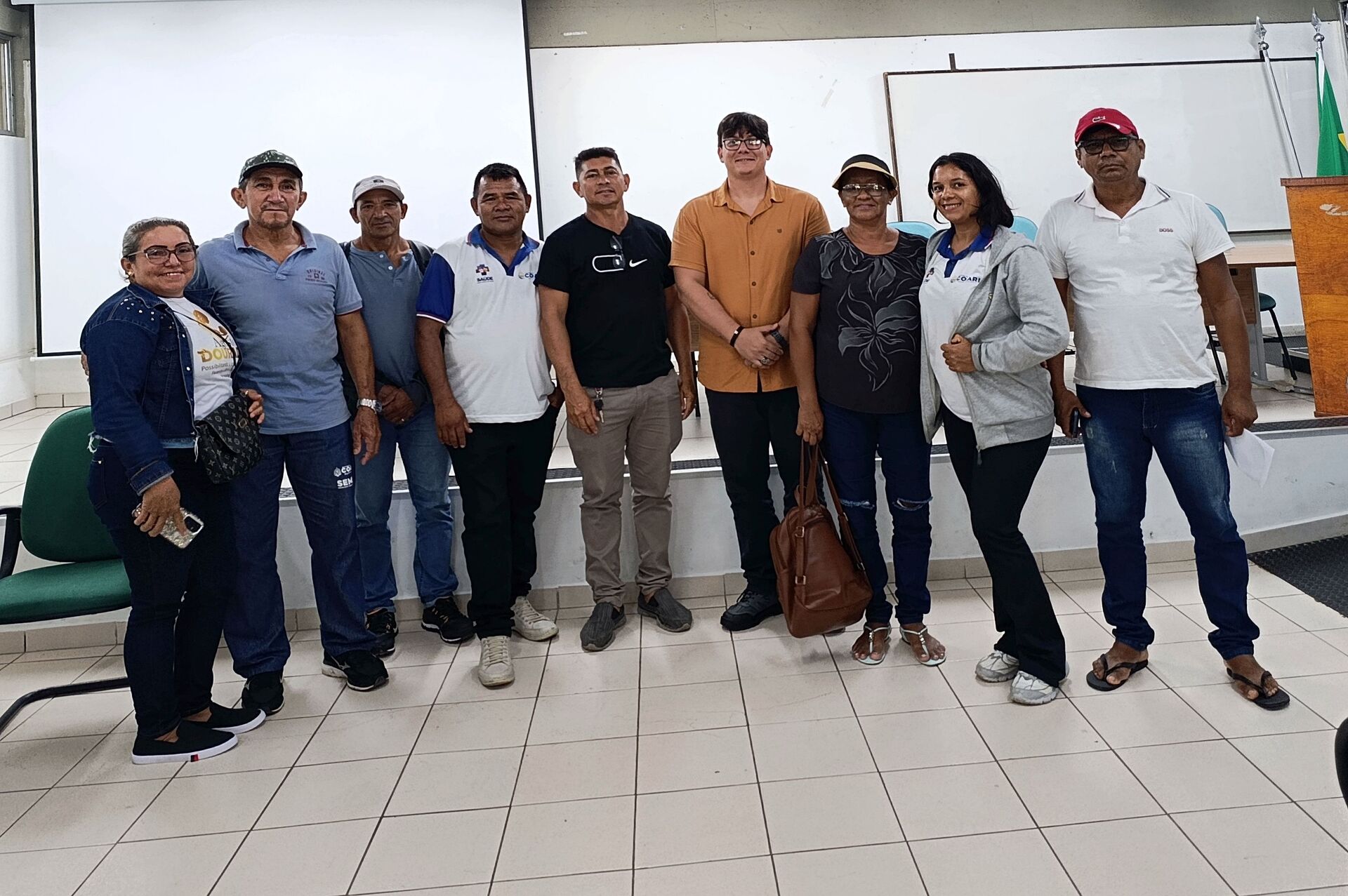 Grupo de agentes comunitários de saúde e pesquisadores reunidos em sala, em Coari
